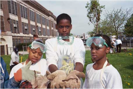 Three youth working at a demonstration booth.