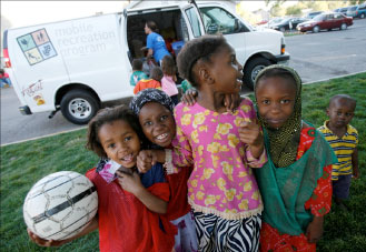Four Youth Grin as They Head Off to Play Soccer. EFNEP Funds the Nan Visits.